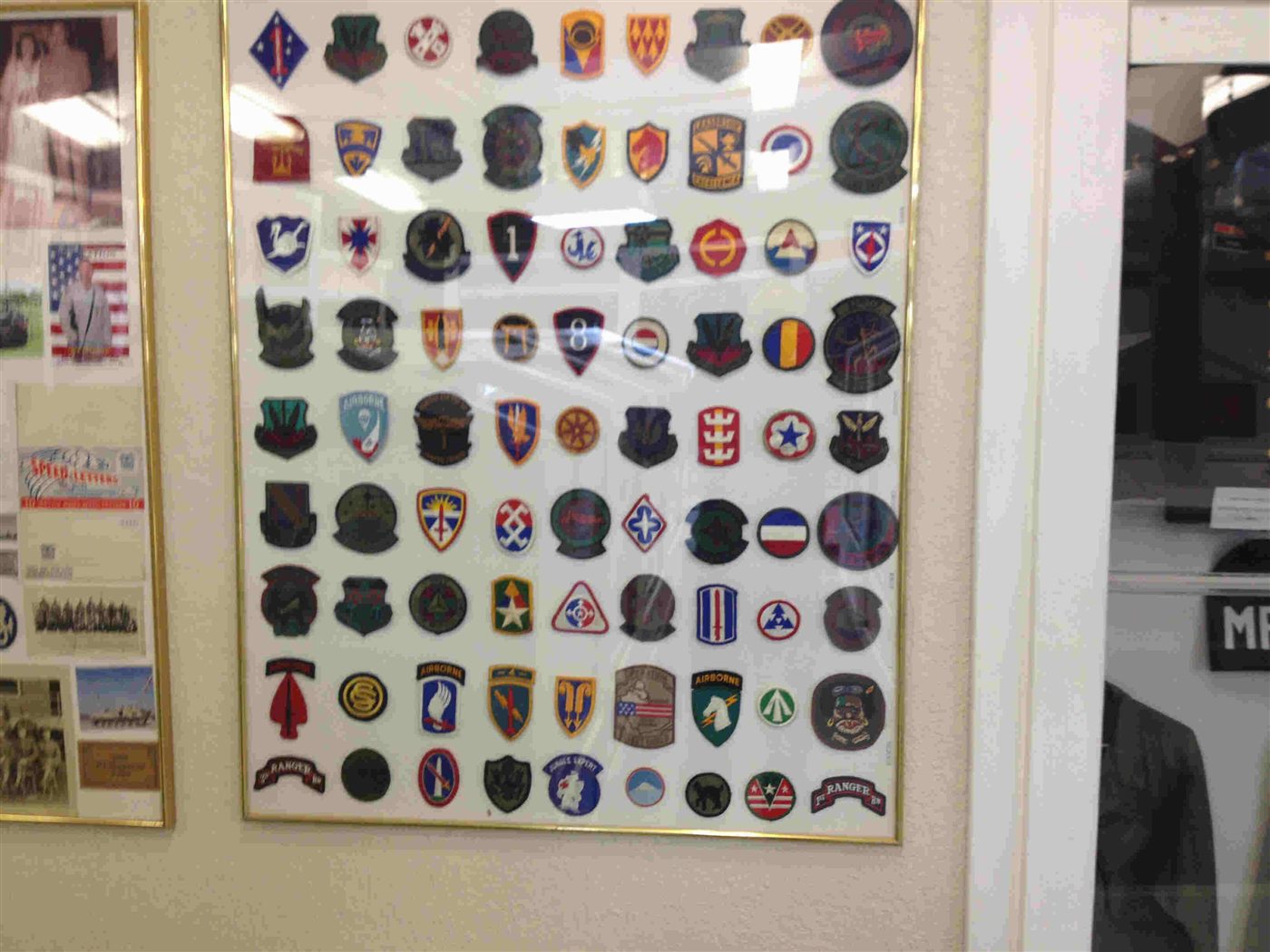 Framed collection of military unit patches